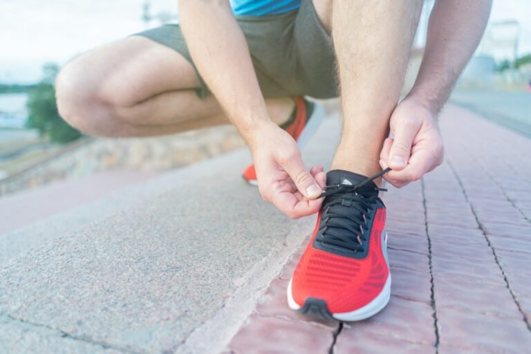 A runner lacing up their shoe before a run