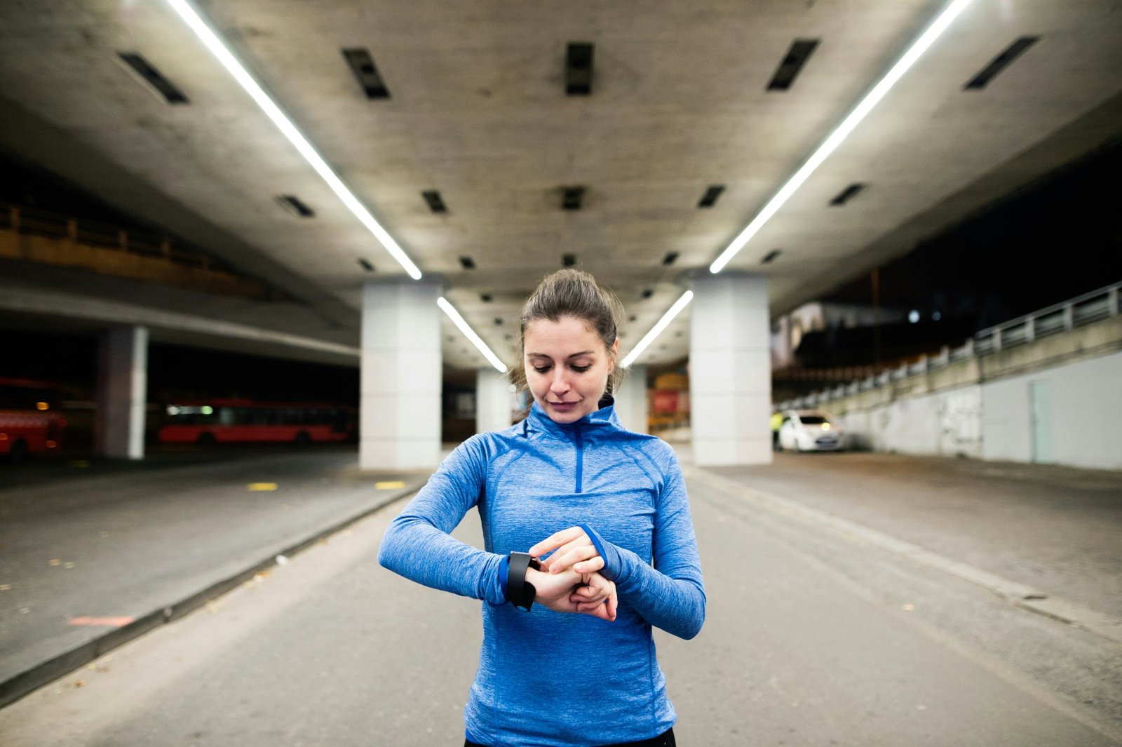 A runner checking the GPS watch on her wrist