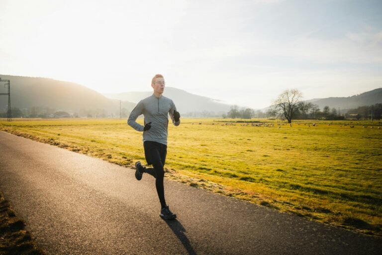 A runner heading out on a quiet road at golden hour