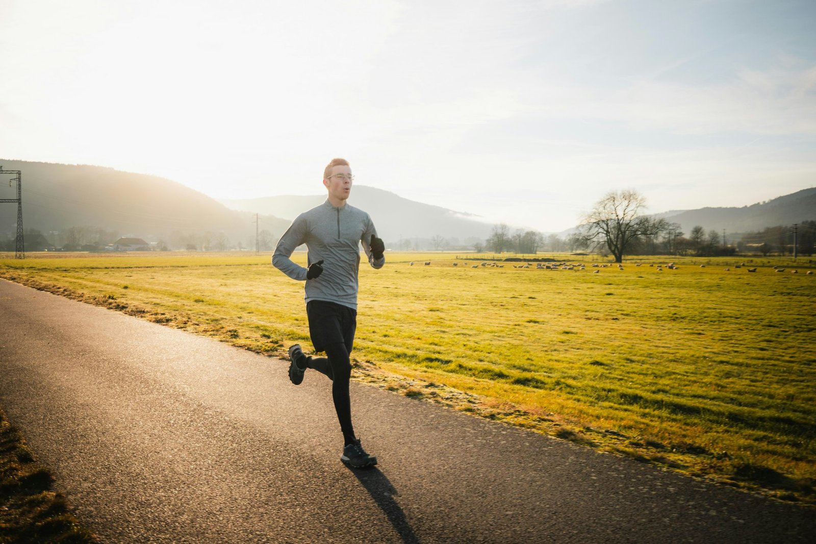 A runner heading out on a quiet road at golden hour