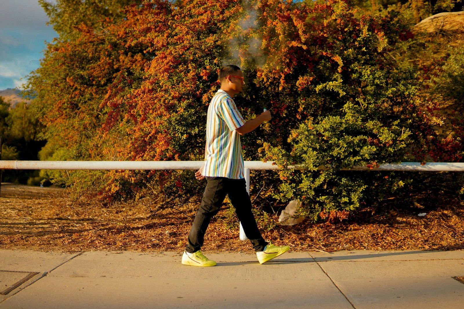 A person taking a walk break on a path in autumn