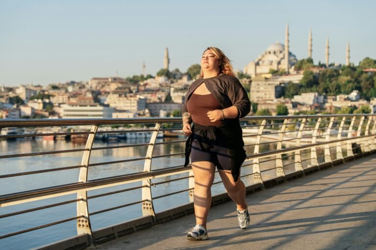 A plus-size runner jogging along a waterfront path