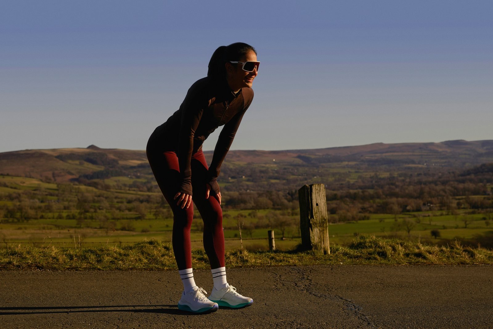 Runner resting with hands on knees after finishing a run
