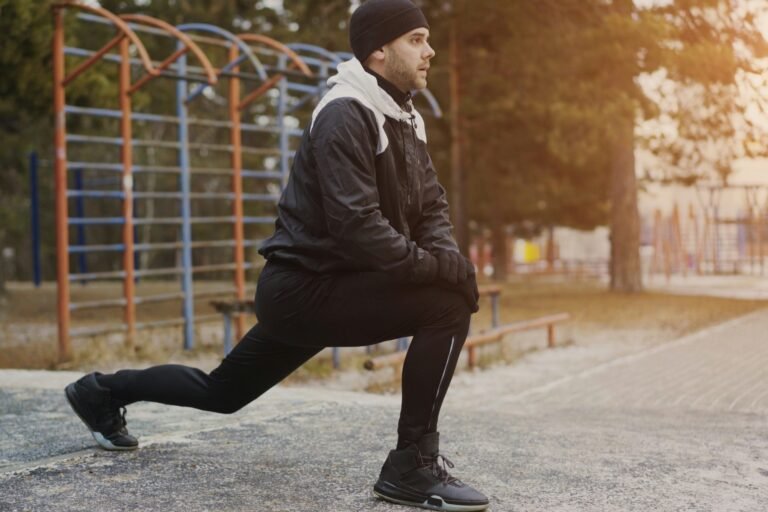 Runner doing a walking lunge as part of a running warm up
